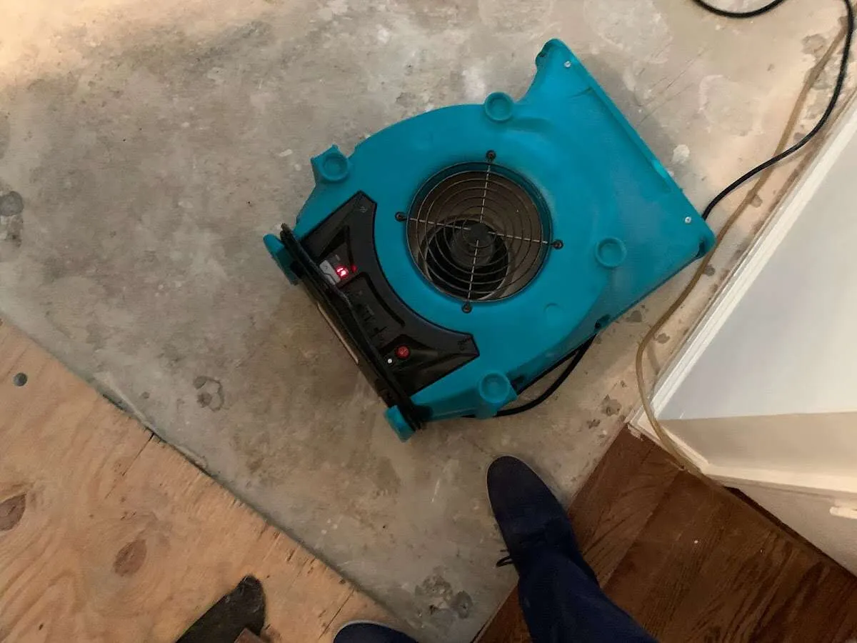 Air mover drying subfloor during Commercial Water Damage Restoration in North Platte